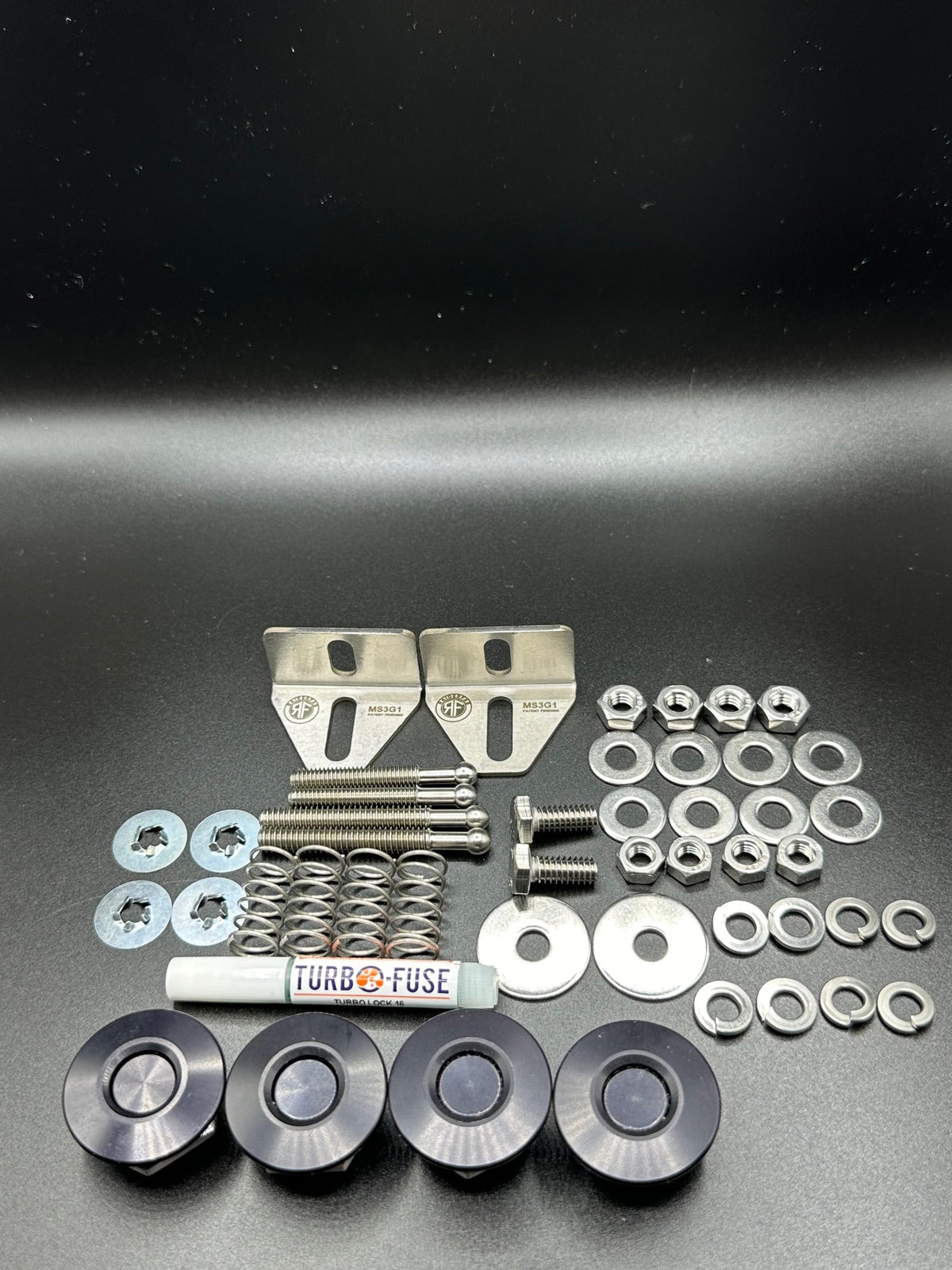 RaiderFab first-generation Mazda3 full bumper kit with four black latches, brackets, threadlocker and hardware.