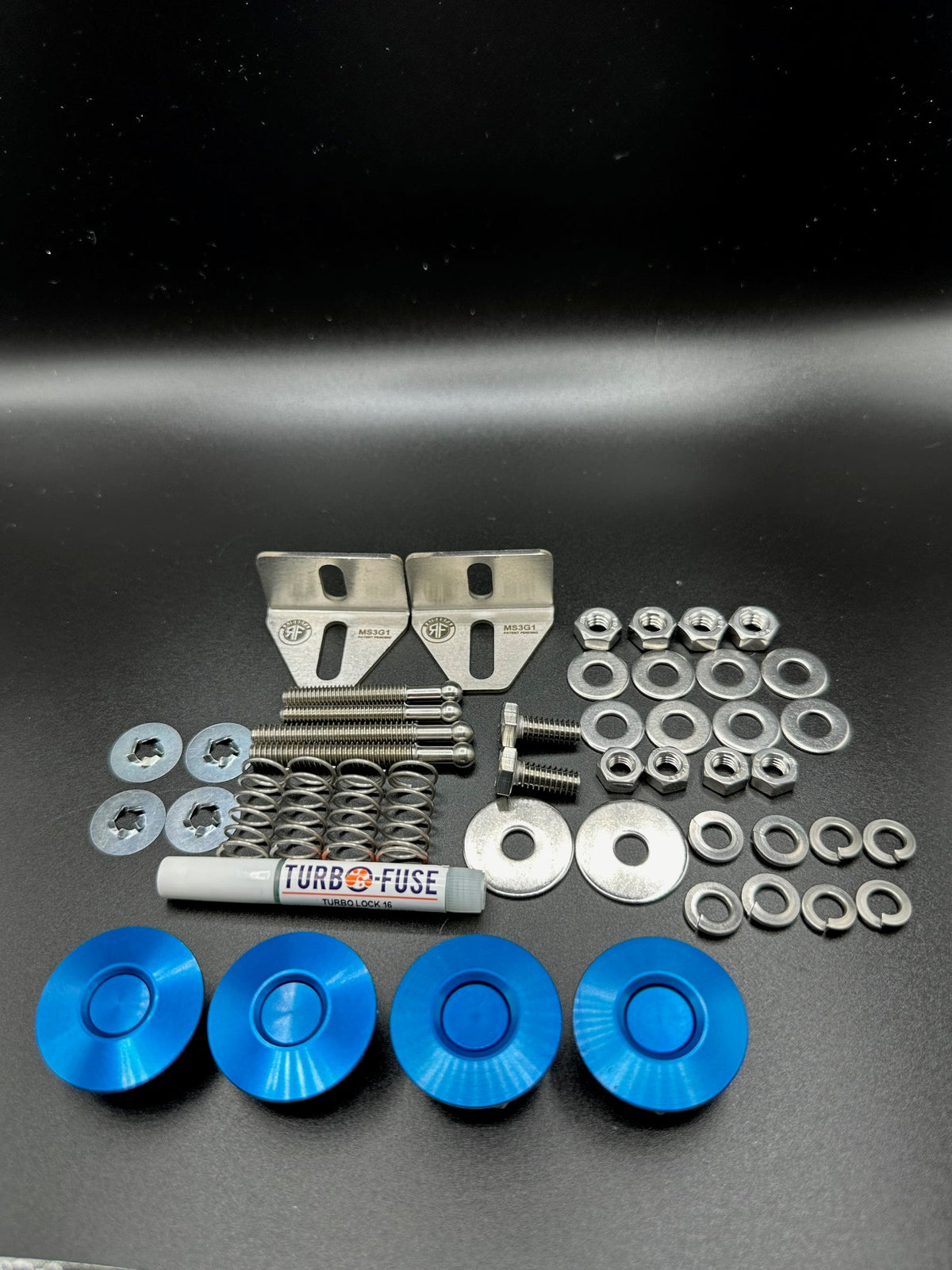 RaiderFab first-generation Mazda3 full bumper kit with four blue latches, brackets, threadlocker and hardware.
