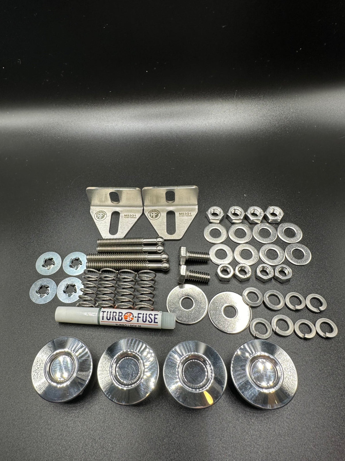 RaiderFab first-generation Mazda3 full kit with four polished latches, brackets, threadlocker and hardware.