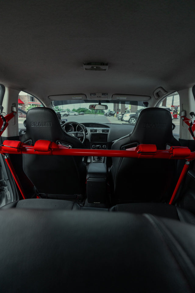 View through the rear cabin toward the front seats and red roll bar.
