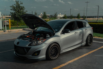 Silver 2012 Mazdaspeed3 customer build with its hood open.