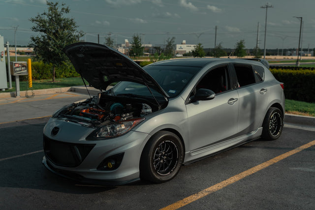 Silver 2012 Mazdaspeed3 customer build with its hood open.