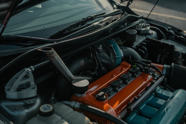 Precision turbocharger and supporting hardware in the Mazdaspeed3 engine bay.