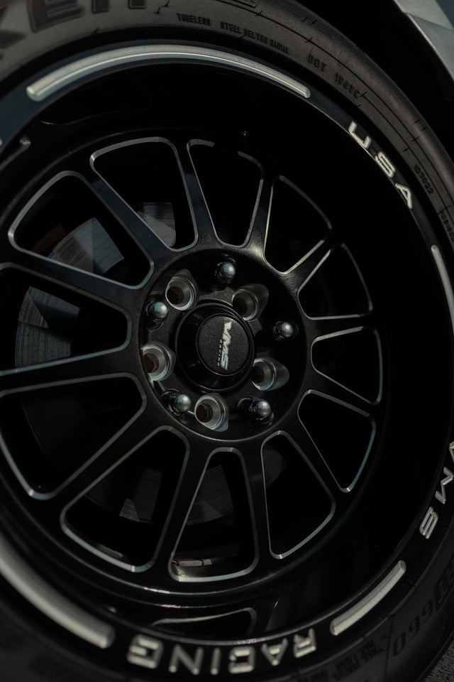 Black VMS Racing wheel wearing a Hoosier drag radial.